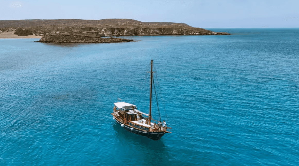 Traditional wooden boat in the turquoise water off Koufonisi