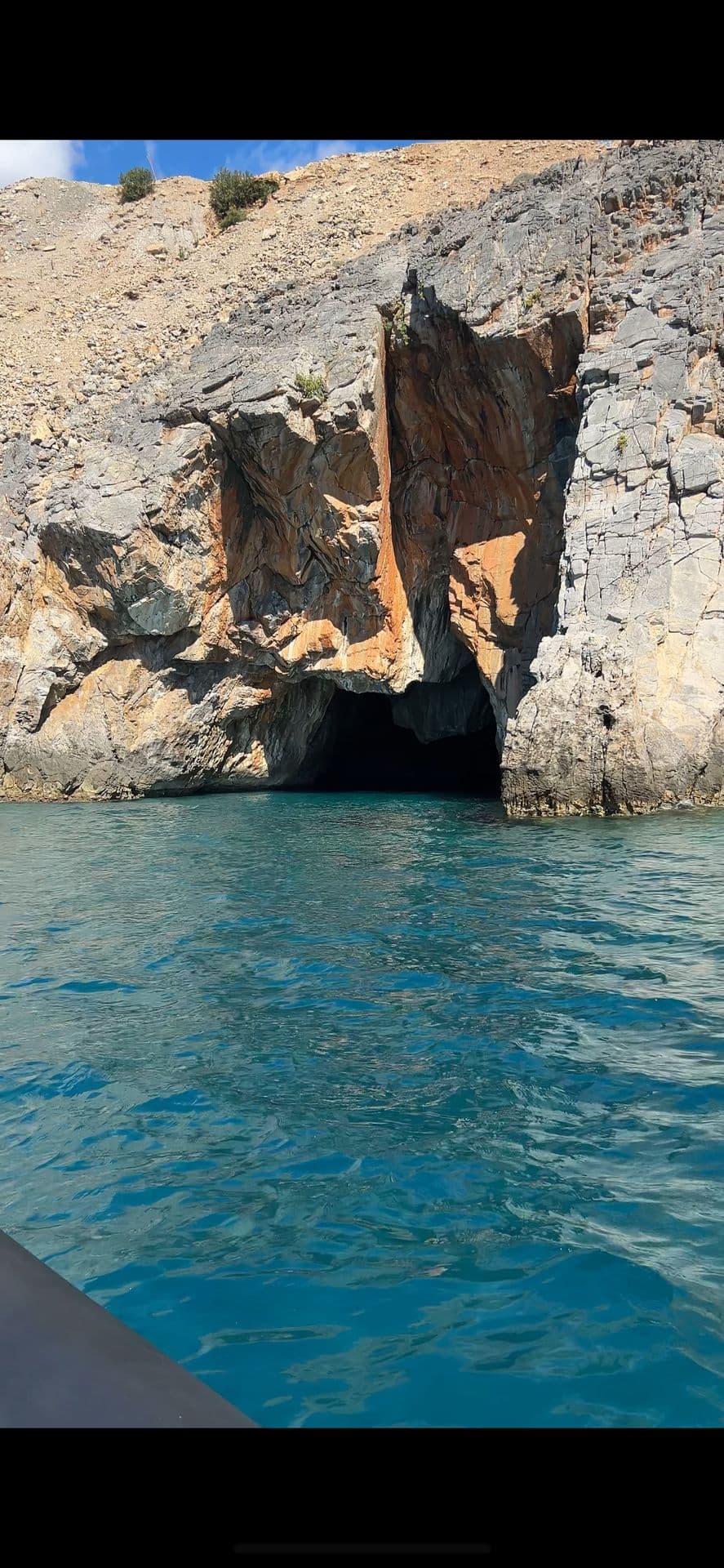 Boat entering a sea cave in South Crete